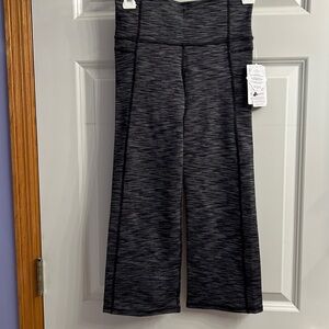 Capri length leggings. Brand new! Cute flare with slit in the back.  Fine stripe